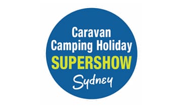 A blue circle with the words caravan camping holiday supershow sydney written underneath it.