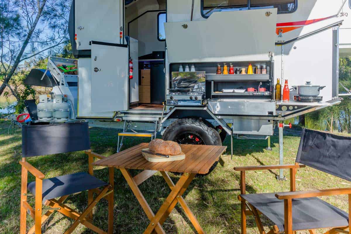 A table and chairs in front of an rv.