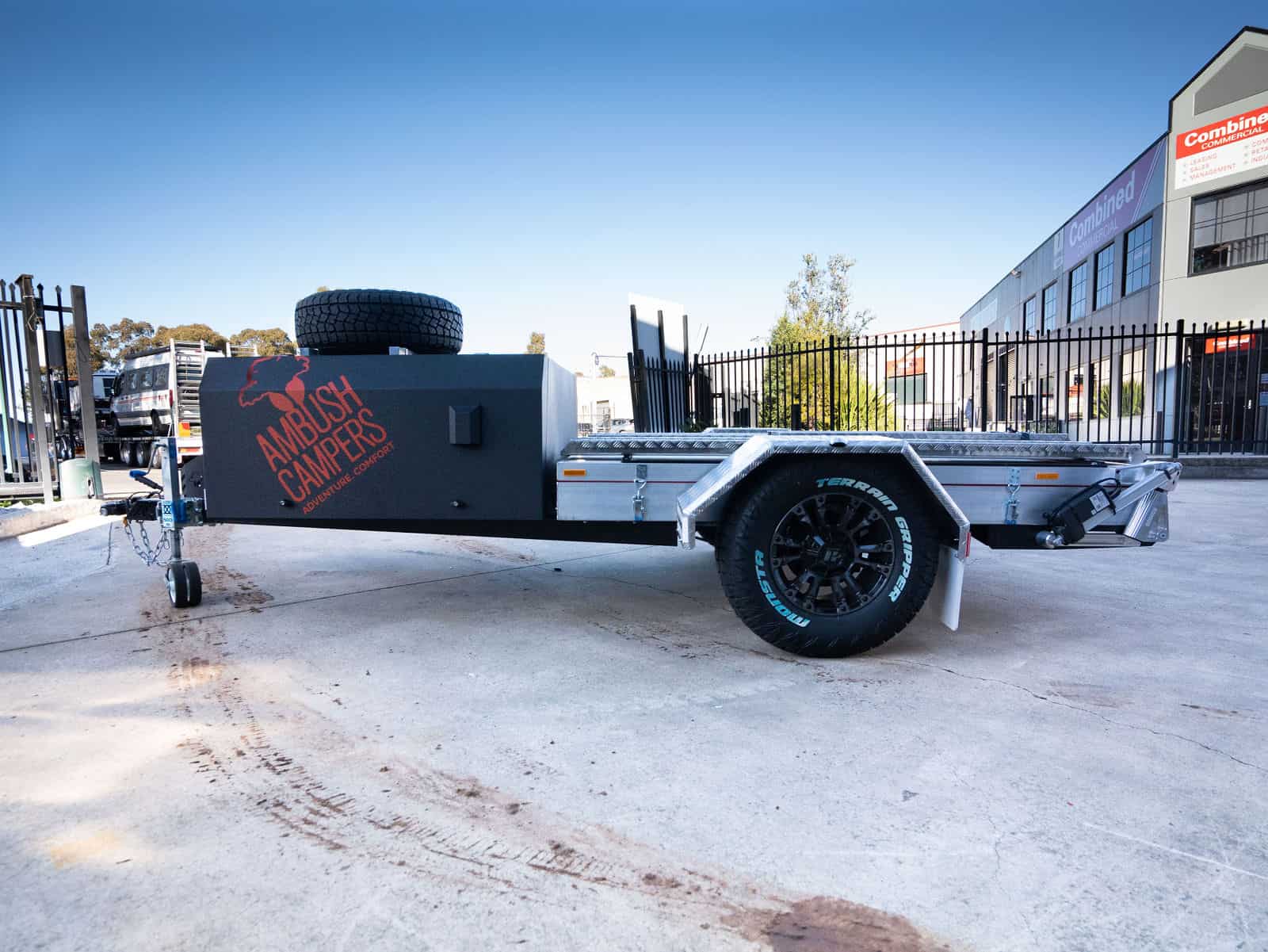 A trailer with a tire on the side of it.