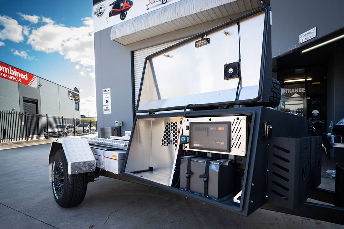 A trailer with a microwave and a large screen tv.