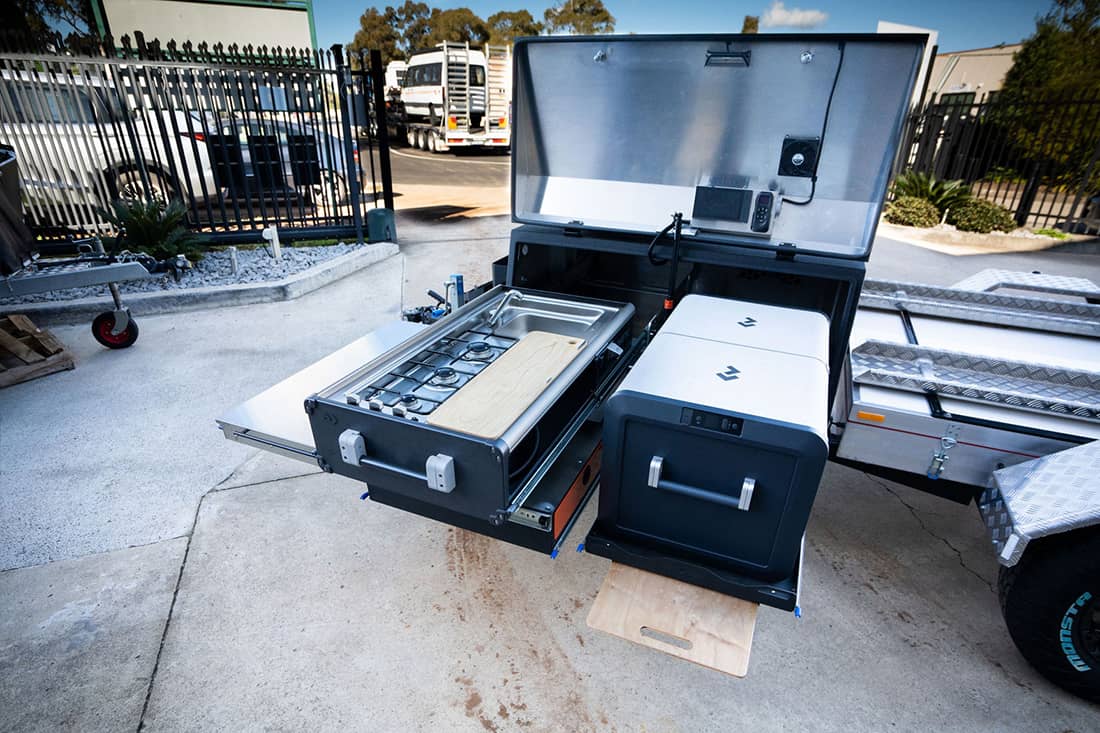 A large metal box with two drawers and one drawer open.