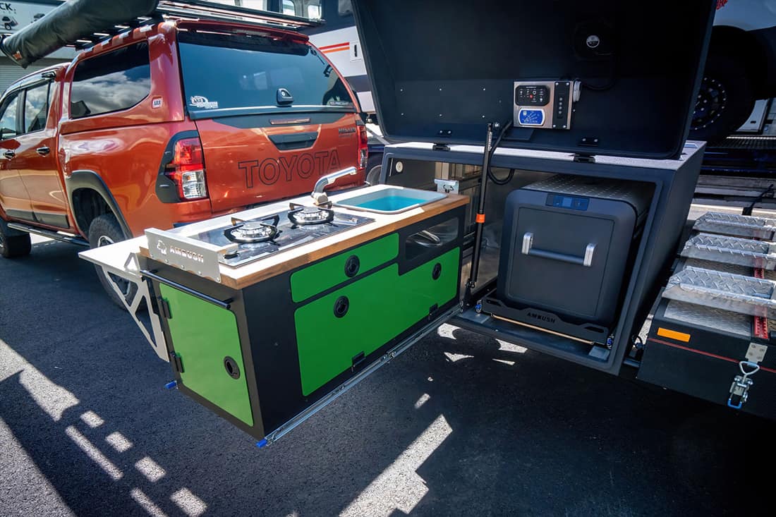 A green and black kitchen with an oven in the back.