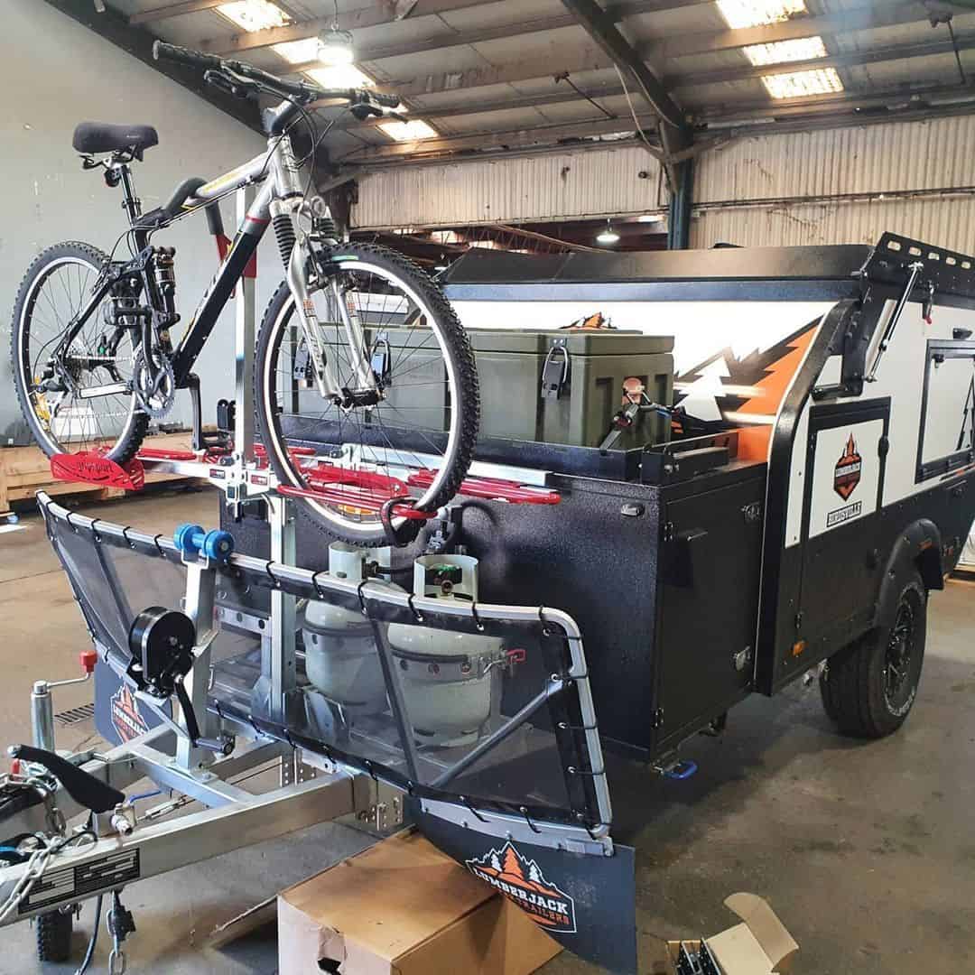 A trailer with a bike on it in a warehouse.