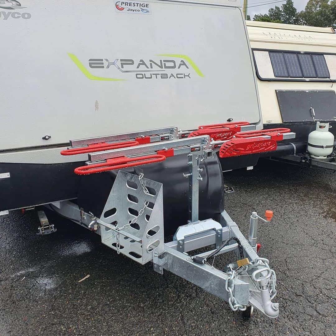 A trailer with two red bars attached to it.