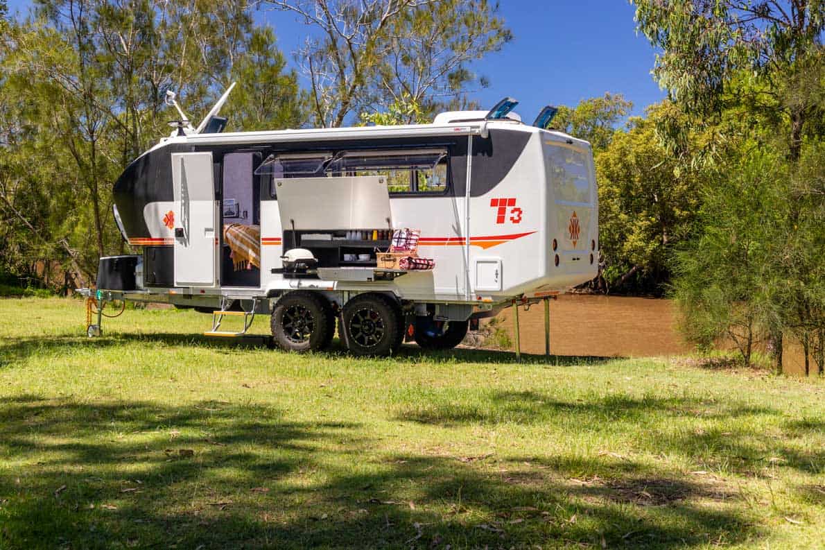 A white trailer with a grill on the back.