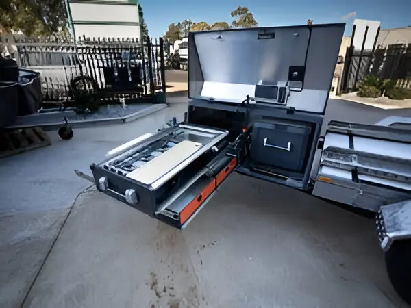 A large metal cart with drawers and a grill.