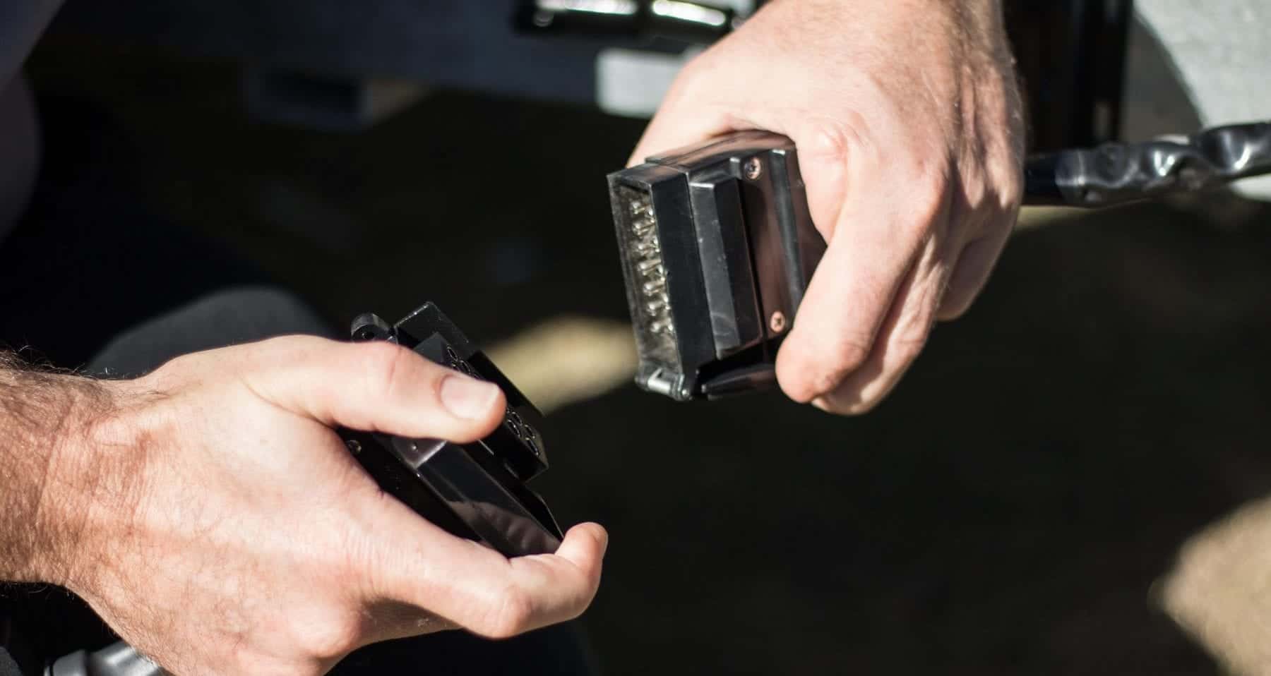 A person holding two cell phones in their hands.