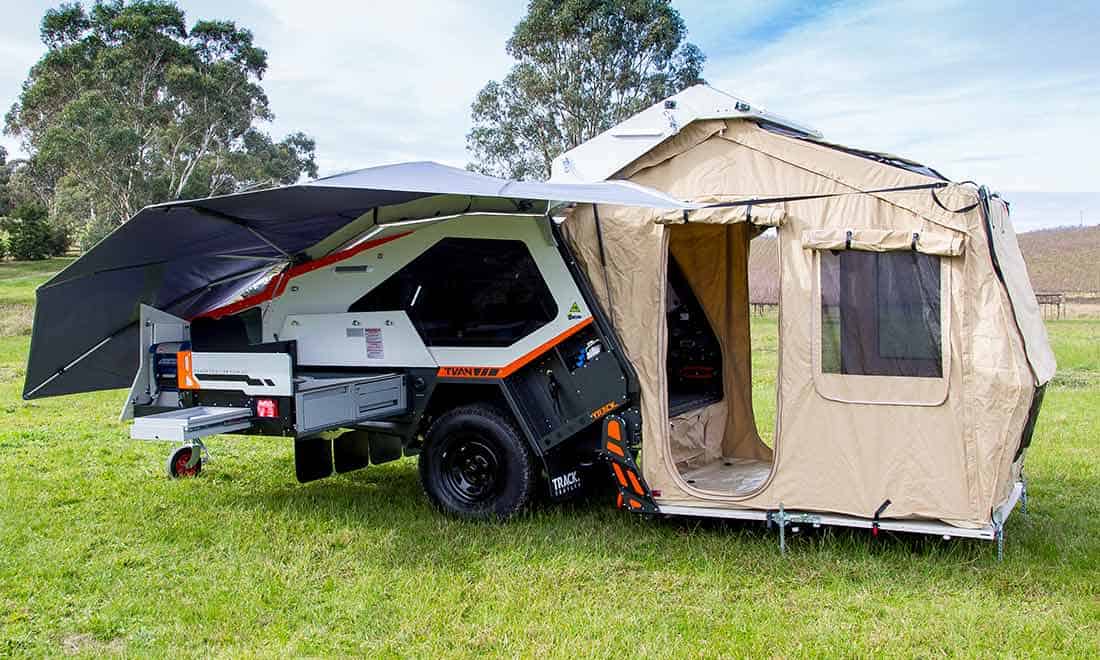 A tent trailer with an awning attached to it.