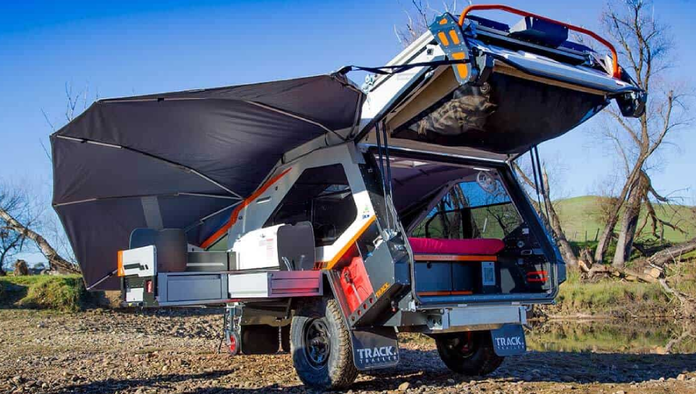 A truck with an awning attached to it's back.