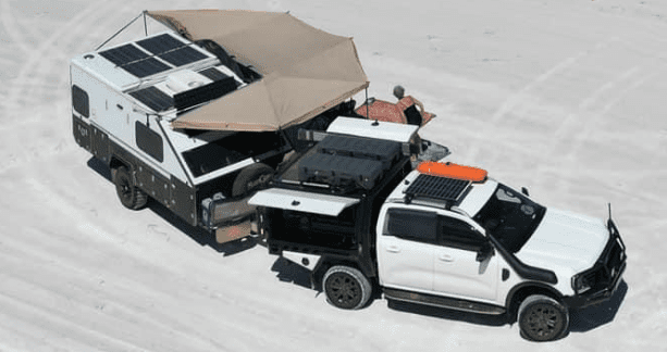 A truck with an awning attached to it's back.