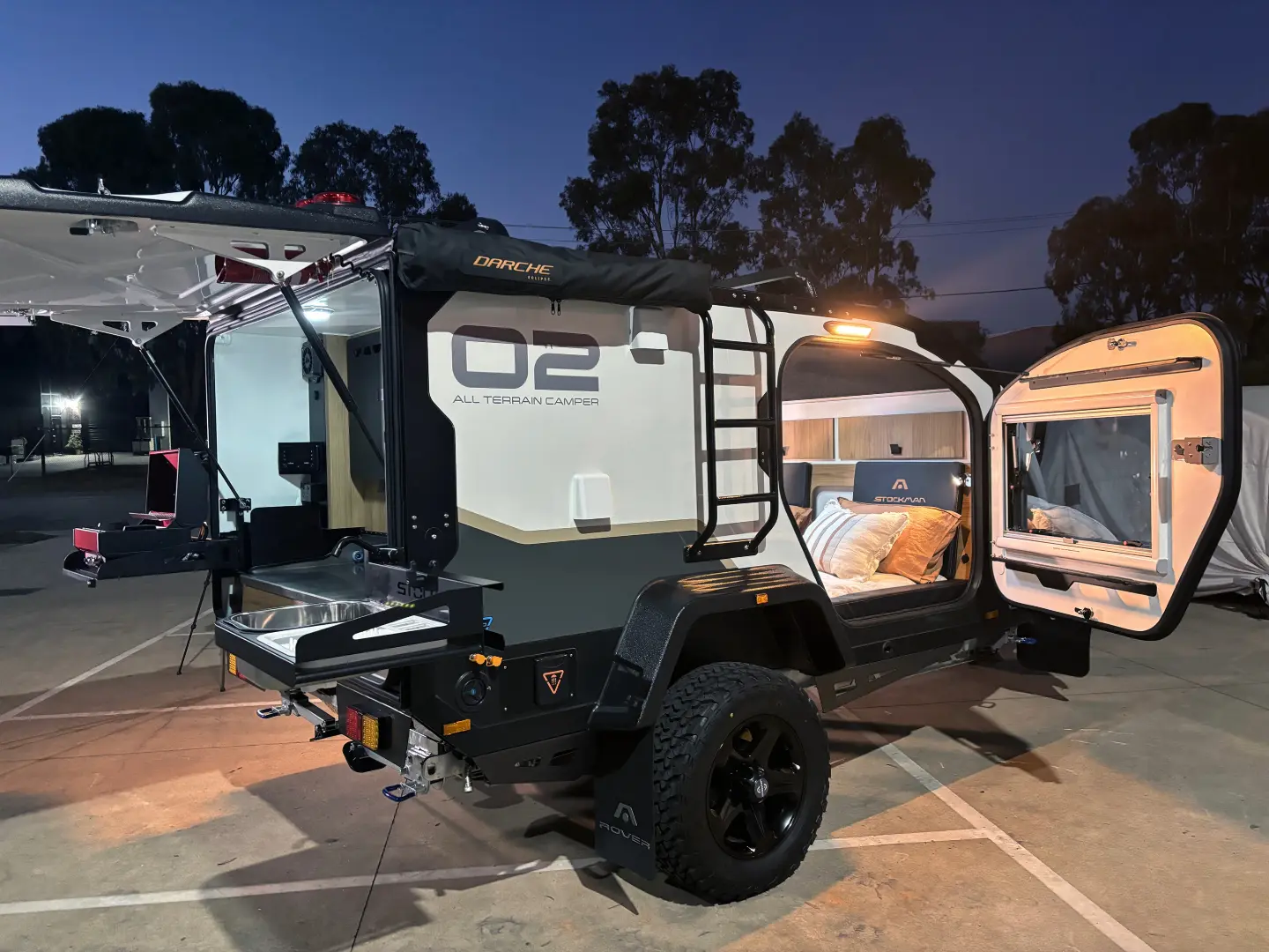 A couple of campers that are parked in the street